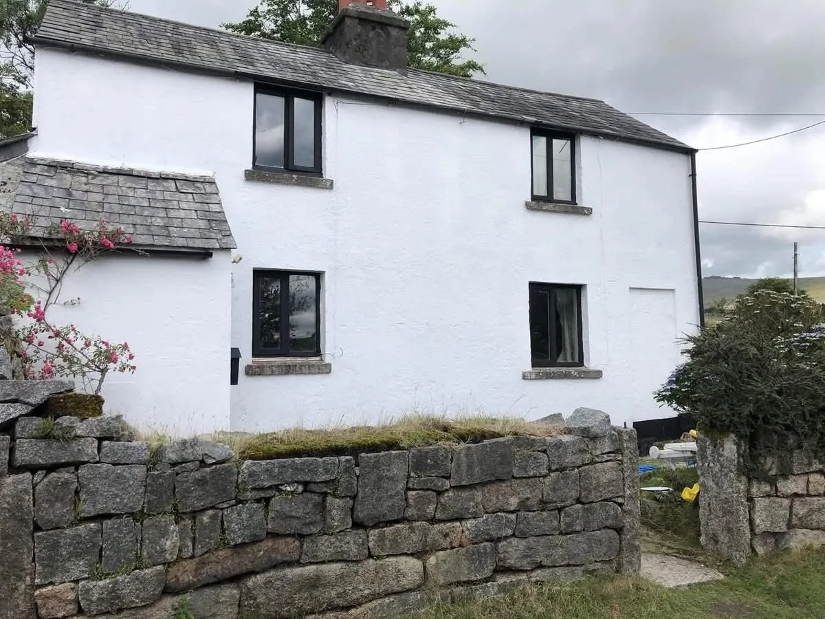 Render repair and exterior repaint of a cottage in Ottery St Mary